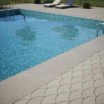 Jeffrey Court Scallop Porcelain Pavers and Pool Herringbone Mosaic installed in an outdoor pool