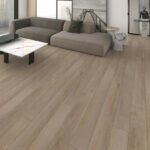 Locale 65 Alexandria Harvest SPC Luxury Vinyl Plank installed in a living room with a grey couch and coffee table