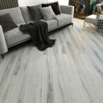 Locale 65 Barcelona Rain SPC Luxury Vinyl Plank installed in a living room with a grey couch